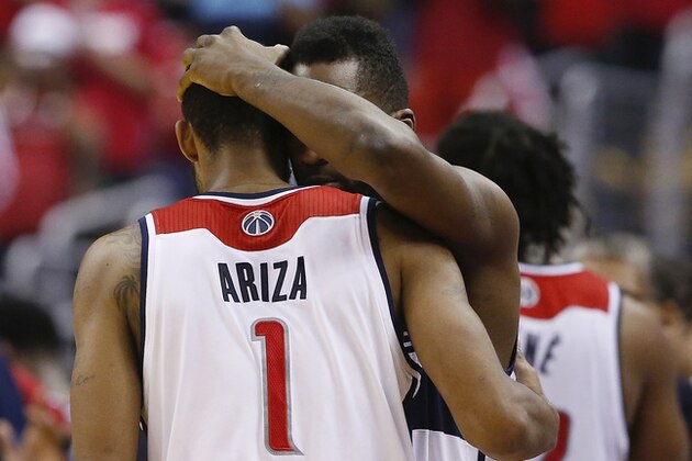 Washington Wizards forwards Trevor Ariza (1) and Martell Webster (9) hug after Game 6 of an Eastern Conference semifinal NBA basketball playoff series in Washington, Thursday, May 15, 2014. The  Indiana Pacers defeated the Wizards 93-80 to advance to the Eastern Conference finals. (AP Photo/Alex Brandon)