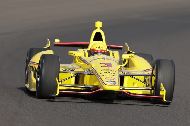 Helio Castroneves, of Brazil, drives through the first turn on the first day of qualifications for Indianapolis 500 IndyCar auto race at the Indianapolis Motor Speedway in Indianapolis, Saturday, May 17, 2014. (AP Photo/Dave Parker)