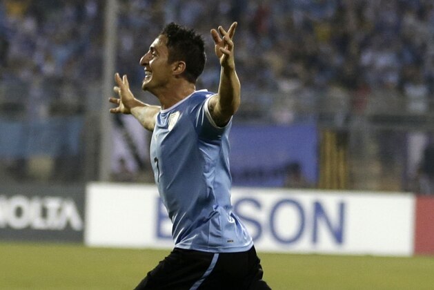 Uruguay's Cristian Rodriguez celebrates scoring a goal against Jordan during the World Cup play off first leg soccer match between Jordan and Uruguay at Amman International stadium in Amman, Jordan, Wednesday, Nov. 13, 2013. (AP Photo/Hassan Ammar)