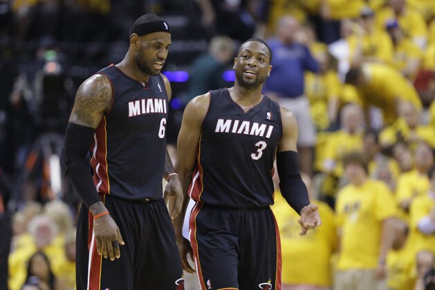 Miami Heat forward LeBron James, left, and guard Dwyane Wade  walk off the court during a time out during the fourth quarter of Game 2 of the NBA basketball Eastern Conference finals against the Indiana Pacers in Indianapolis, Tuesday, May 20, 2014. The Heat defeated the Pacers 87-83 to tie the series at 1-1. (AP Photo/Michael Conroy)