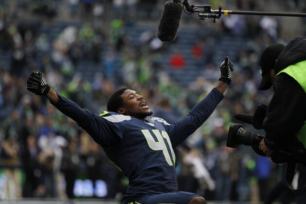 Seattle Seahawks cornerback Byron Maxwell yells as he is filmed while stretching before an NFL football game against the St. Louis Rams, Sunday, Dec. 29, 2013, in Seattle. (AP Photo/John Froschauer)