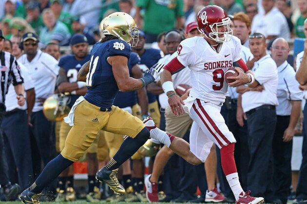 SOUTH BEND, IN - SEPTEMBER 28: Trevor Knight #9 of the Oklahoma Sooners runs for a first down chased by Matthias Farley #41 of the Notre Dame Fighting Irish at Notre Dame Stadium on September 28, 2013 in South Bend, Indiana. Oklahoma defeated Notre Dame 35-21. (Photo by Jonathan Daniel/Getty Images)