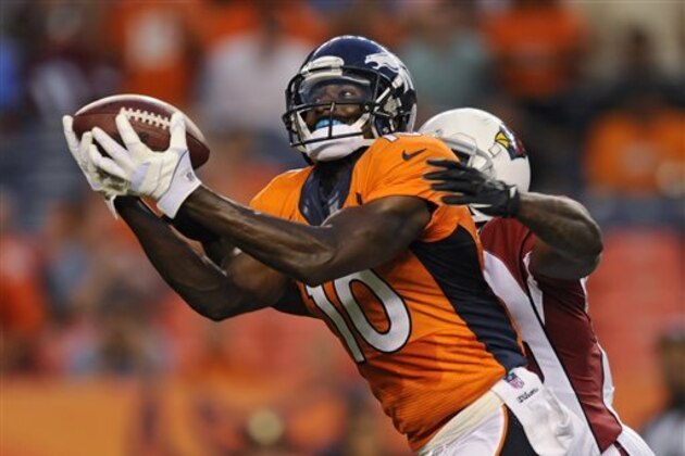 Denver Broncos wide receiver Gerell Robinson (10) catches a pass as Arizona Cardinals' Javier Arenas defends during the first quarter of a preseason NFL football game, Thursday, Aug. 29, 2013, in Denver. (AP Photo/Jack Dempsey)