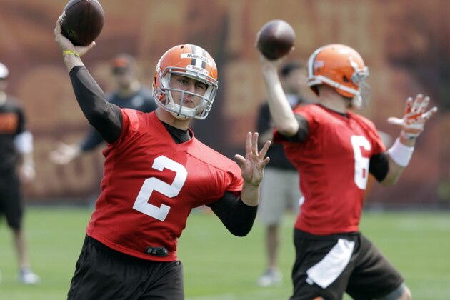 Cleveland Browns quarterback Johnny Manziel (2) passes with Brian Hoyer (6) during a practice at the NFL football team's facility in Berea, Ohio Wednesday, May 21, 2014. (AP Photo/Mark Duncan)