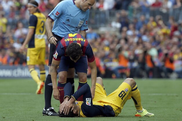 Atletico's Diego Costa lies injured on the pitch during a Spanish La Liga soccer match between FC Barcelona and Atletico Madrid at the Camp Nou stadium in Barcelona, Spain, Saturday, May 17, 2014. (AP Photo/Emilio Morenatti)