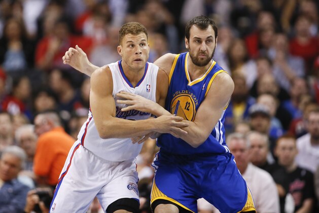 Golden State Warriors' Andrew Bogut and Los Angeles Clippers' Blake Griffin battle for position during the first half of an NBA basketball game in Los Angeles, Wednesday, March 12, 2014. (AP Photo/Danny Moloshok)