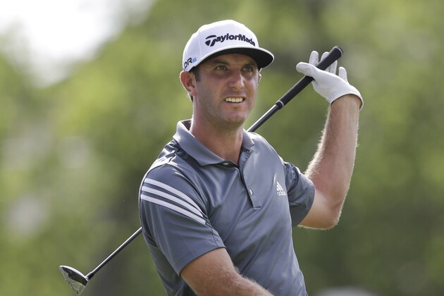 Dustin Johnson watches his tee shot on the 18th hole during the first round of the PGA Colonial golf tournament in Fort Worth, Texas, Thursday, May 22, 2014.   (AP Photo/LM Otero)