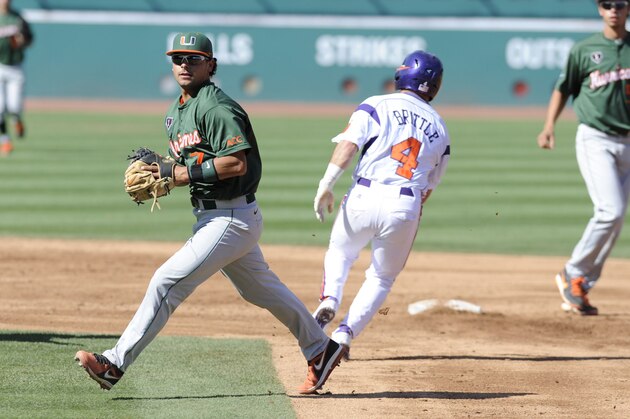 May 25, 2013; Durham, NC, USA; Miami Hurricanes infielder Alexander Hernandez (7) tags out Clemson Tigers base runner Thomas Brittle (4) on a double play during the ACC baseball tournament at Durham Bulls Athletic Park. Mandatory Credit: Liz Condo-USA TODAY Sports