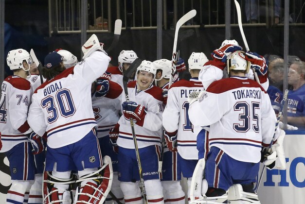 The Montreal Canadiens celebrate after defeating the New York Rangers 3-2 in overtime in Game 3 of the NHL hockey Stanley Cup playoffs Eastern Conference finals, Thursday, May 22, 2014, in New York. (AP Photo/Kathy Willens)
