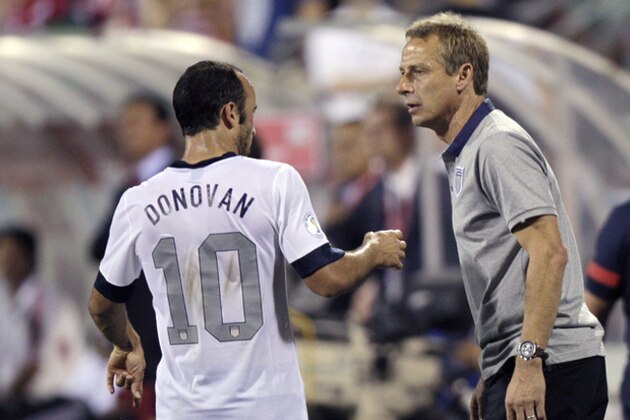 In this photo taken Tuesday, Sept. 10, 2013, United States manager Jurgen Klinsmann, right, talks with Landon Donovan during a World Cup qualifying soccer match against Mexico in Columbus, Ohio. The United States clinched its seventh straight World Cup appearance, getting second-half goals from Eddie Johnson and Donovan on Tuesday night in a 2-0 win over Mexico.(AP Photo/Jay LaPrete)