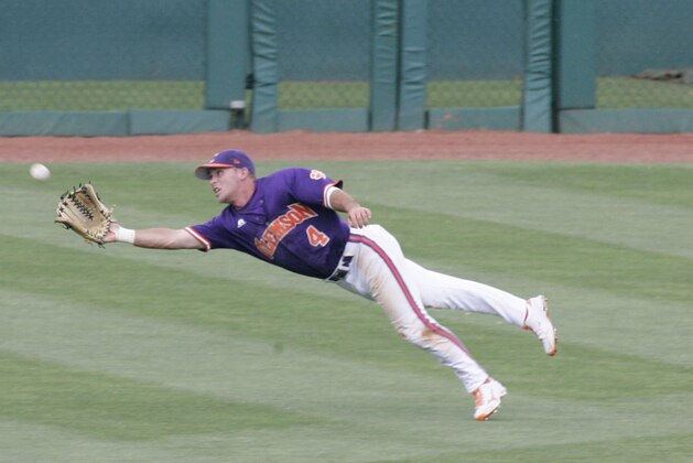 Clemson's center fielder Thomas Brittle (4) makes a diving catch of Liberty's Dalton Britt in the  third inning of an NCAA college baseball tournament regional game on Sunday, June 2, 2013, in Columbia, S.C. (AP Photo/Mary Ann Chastain)