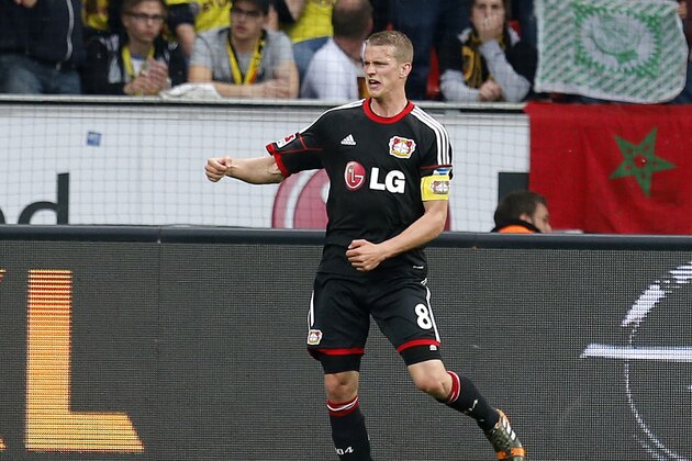 Leverkusen's Lars Bender celebrates his side's opening goal during a German Bundesliga soccer match between Bayer 04 Leverkusen and Borussia Dortmund in Leverkusen, Germany, Saturday, April 26, 2014. (AP Photo/Michael Probst)