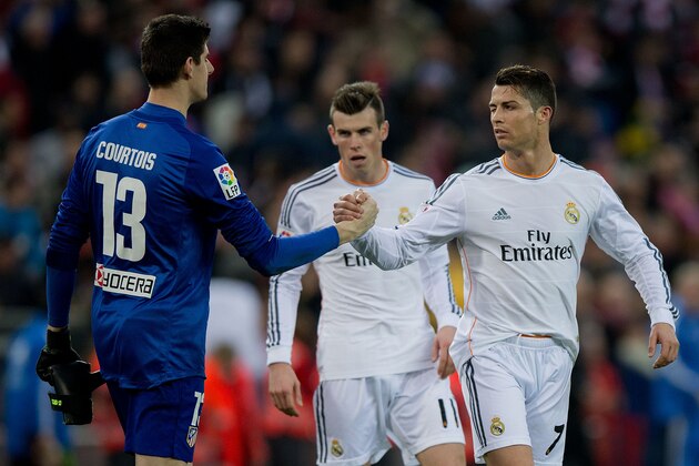 MADRID, SPAIN - MARCH 02: Cristiano Ronaldo (L) of Real Madrid CF wrinkles his eye and shakes hands with  goalkeeper Thibaut Courtois (L) of Atletico de Madrid after the La Liga match between Club Atletico de Madrid and Real Madrid CF at Vicente Calderon Stadium on March 2, 2014 in Madrid, Spain.  (Photo by Gonzalo Arroyo Moreno/Getty Images)