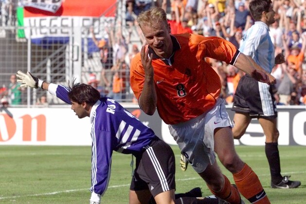 Holland's Dennis Bergkamp jubilates after scoring the winning goal against Argentina's goalkeeper Carlos Roa during the quarter final France 98 soccer world cup match Argentina vs. the Netherlands at the Velodrome stadium in Marseille Saturday  July 4, 1998. Holland won 2-1 and will meet Brazil in the semi-finals. (AP Photo/Ricardo Mazalan)