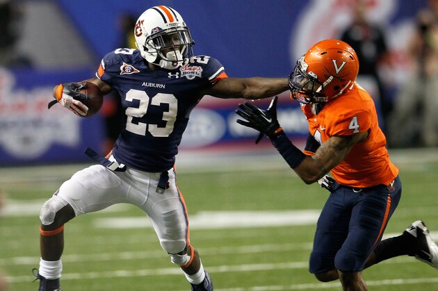 ATLANTA, GA - DECEMBER 31:  Onterio McCalebb #23 of the Auburn Tigers stiff arms Rodney McLeod #4 of the Virginia Cavaliers during the 2011 Chick Fil-A Bowl at Georgia Dome on December 31, 2011 in Atlanta, Georgia.  (Photo by Kevin C. Cox/Getty Images)