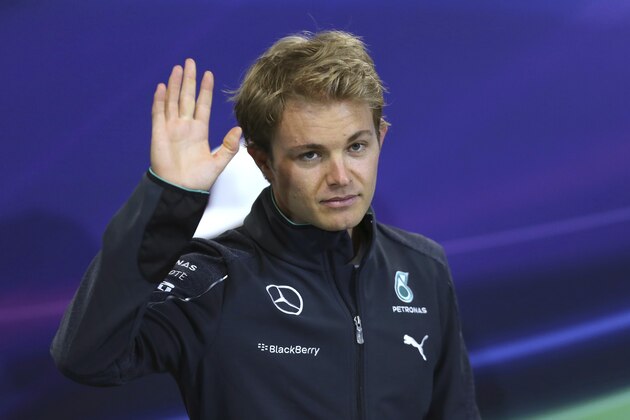 Mercedes driver Nico Rosberg, of Germany, waves as he arrives for a press conference in Monaco, Wednesday, May 21, 2014. The Monaco Formula One Grand Prix will be held on Sunday. (AP Photo/Antonio Calanni)