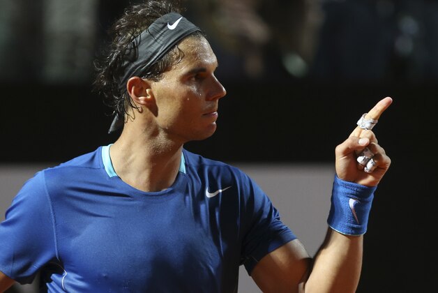Spain's Rafael Nadal celebrates after winning his match against France's Gilles Simon at the Italian open tennis tournament in Rome, Wednesday, May 14, 2014. (AP Photo/Gregorio Borgia)