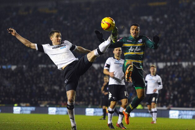 DERBY, ENGLAND - FEBRUARY 10: Craig Forsyth of Derby County battles with Jermaine Jenas of Queens Park Rangers during the Sky Bet Championship match between Derby County and Queens Park Rangers on February 10, 2014 in Derby, England.  (Photo by Laurence Griffiths/Getty Images)