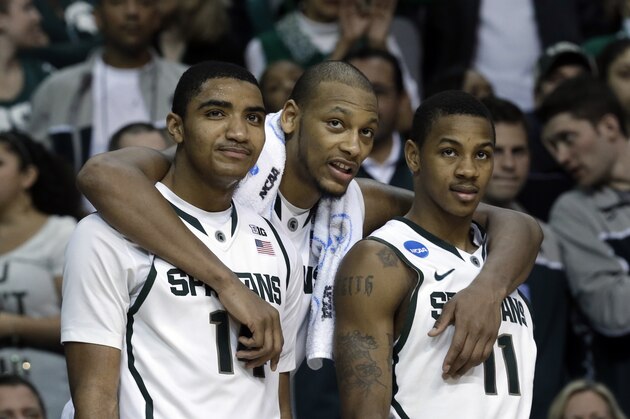 Michigan State guard Gary Harris, from left, forward Adreian Payne (5), and Keith Appling watch the final moments from the bench against Memphis in the second half of their third-round game of the NCAA college basketball tournament in Auburn Hills, Mich., Saturday March 23, 2013. Michigan State won 70-48. (AP Photo/Paul Sancya)