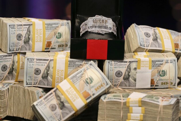 The championship bracelet is displayed on a pile of money before the start of the World Series of Poker final table, Tuesday, Nov. 5, 2013, in Las Vegas. Two finalists remain in the game playing for an $8.4 million crown. (AP Photo/Julie Jacobson)