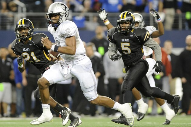 Denton Guyer Jerrod Heard (2) runs upfield past Northside Brennan's Llandre Mitchell (21) and DJ Allen (5) for a second half of the UIL Class 4A Division I high school football championship game, Friday Dec. 20, 2013, in Arlington, Texas. (AP Photo/Matt Strasen)