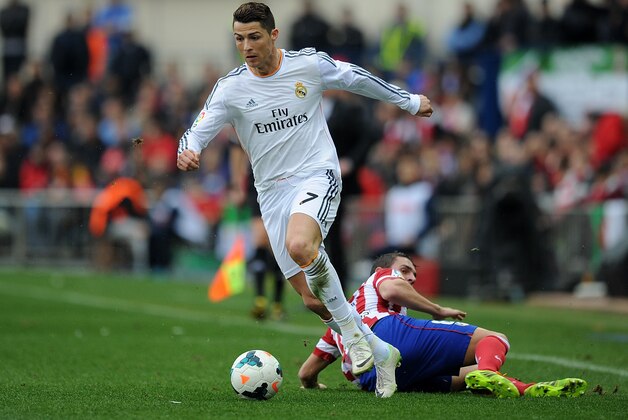 MADRID, SPAIN - MARCH 02:  Cristiano Ronaldo (L) of Real Madrid CF beats Raul Garcia of Club Atletico de Madrid during the La Liga match between Club Atletico de Madrid and Real Madrid CF  at Vicente Calderon Stadium on March 2, 2014 in Madrid, Spain.  (Photo by Denis Doyle/Getty Images)
