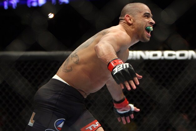 Renan Barao celebrates after beating Urijah Faber of Sacramento, CA during the first round of the Ultimate Fighting Bantamweight Championship Mixed Martial Arts bout in Newark, N.J. on Saturday, Feb. 1, 2014. Barao won after referee Herb Dean called the fight in the first round. (AP Photo/Tim Larsen)