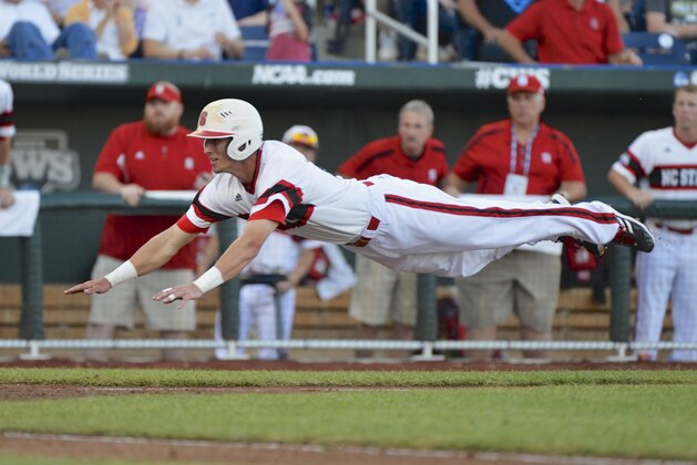 North Carolina State's Jake Armstrong leaps towards home plate before being tagged out by UCLA pitcher Nick Vander Tuig, following a single by Trea Turner in the third inning of an NCAA College World Series game in Omaha, Neb., Tuesday, June 18, 2013. (AP Photo/Ted Kirk)