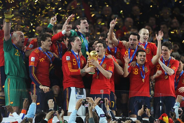 JOHANNESBURG, SOUTH AFRICA - JULY 11:  David Villa and Sergio Ramos of Spain lift the World Cup trophy as the Spain team celebrate victory following the 2010 FIFA World Cup South Africa Final match between Netherlands and Spain at Soccer City Stadium on July 11, 2010 in Johannesburg, South Africa.  (Photo by Jasper Juinen/Getty Images)