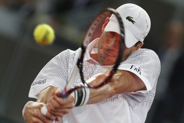 John Isner from the U.S. returns the ball during a Madrid Open tennis tournament match against David Ferrer from Spain in Madrid, Spain, Thursday, May 8, 2014. (AP Photo/Andres Kudacki)