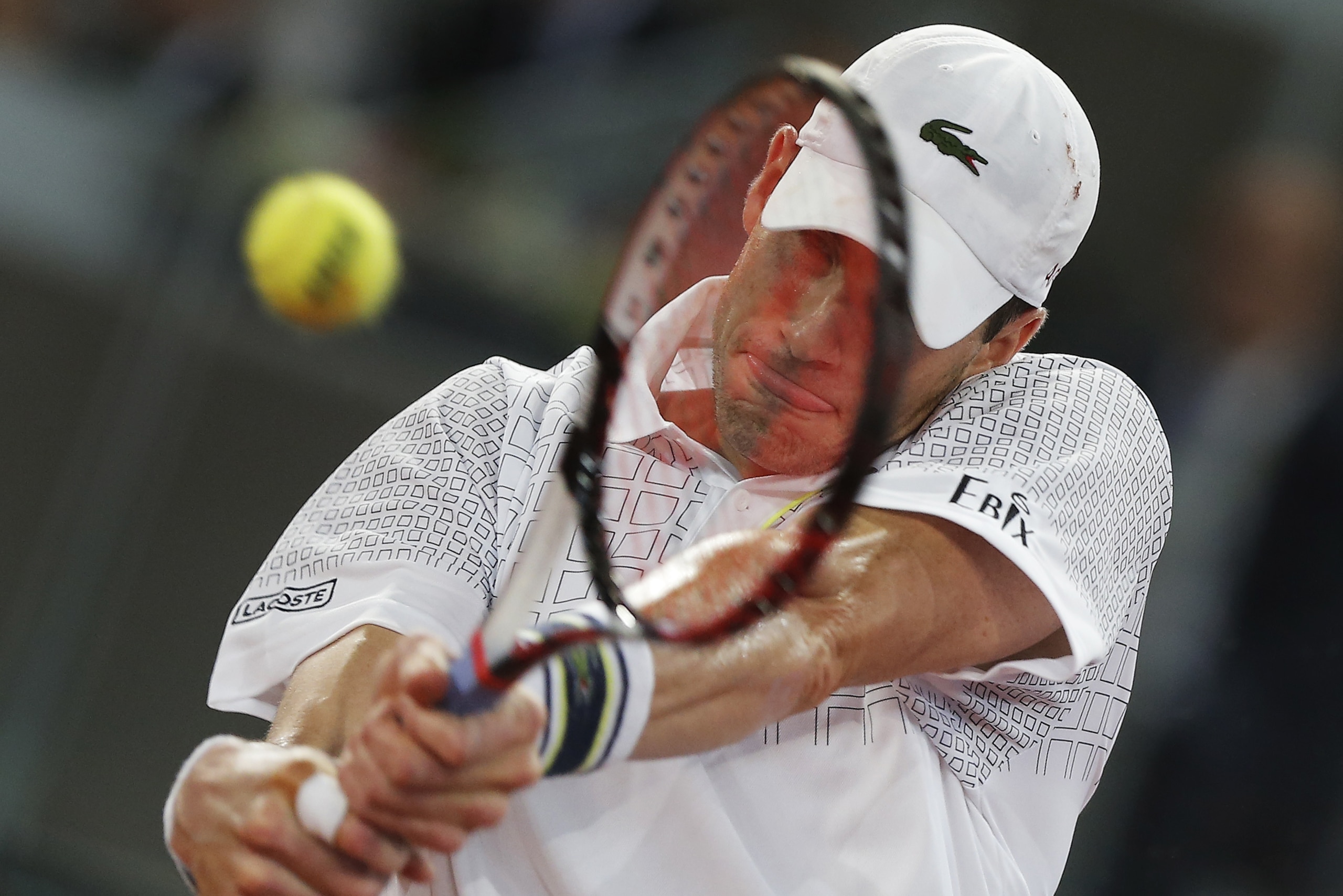 John Isner from the U.S. returns the ball during a Madrid Open tennis tournament match against David Ferrer from Spain in Madrid, Spain, Thursday, May 8, 2014. (AP Photo/Andres Kudacki)