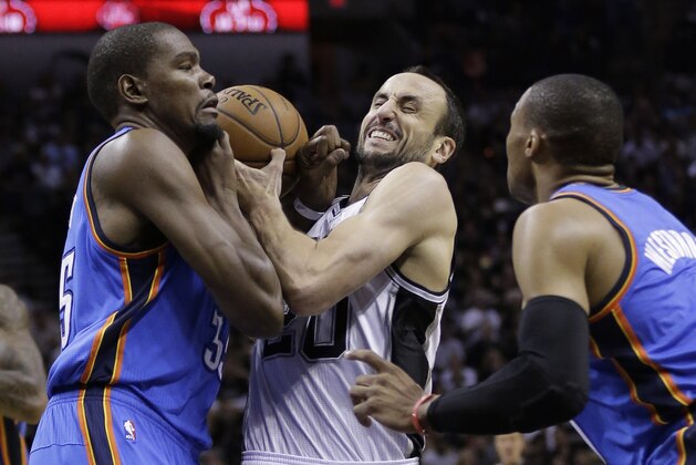 San Antonio Spurs' Manu Ginobili, center, tries to drive between Oklahoma City Thunder's Kevin Durant, left, and Russell Westbrook during the first half of Game 2 of the Western Conference finals NBA basketball playoff series, Wednesday, May 21, 2014, in San Antonio. (AP Photo/Eric Gay)