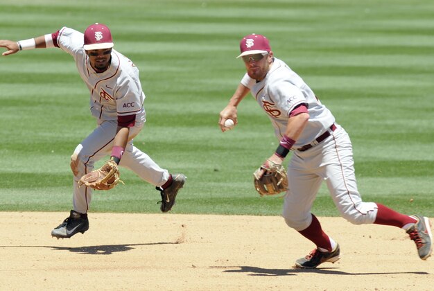 May 25, 2013; Durham, NC, USA; Florida State Seminoles infielder Giovanny Alfonzo (left) backs up teammate Casey Smit (43) on a ground ball during their game against the Virginia Cavaliers during the ACC baseball tournament at Durham Bulls Athletic Park. Virginia won 7-4 in 12 innings. Mandatory Credit: Liz Condo-USA TODAY Sports