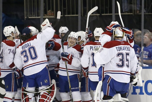 The Montreal Canadiens celebrate after defeating the New York Rangers 3-2 in overtime in Game 3 of the NHL hockey Stanley Cup playoffs Eastern Conference finals, Thursday, May 22, 2014, in New York. (AP Photo/Kathy Willens)