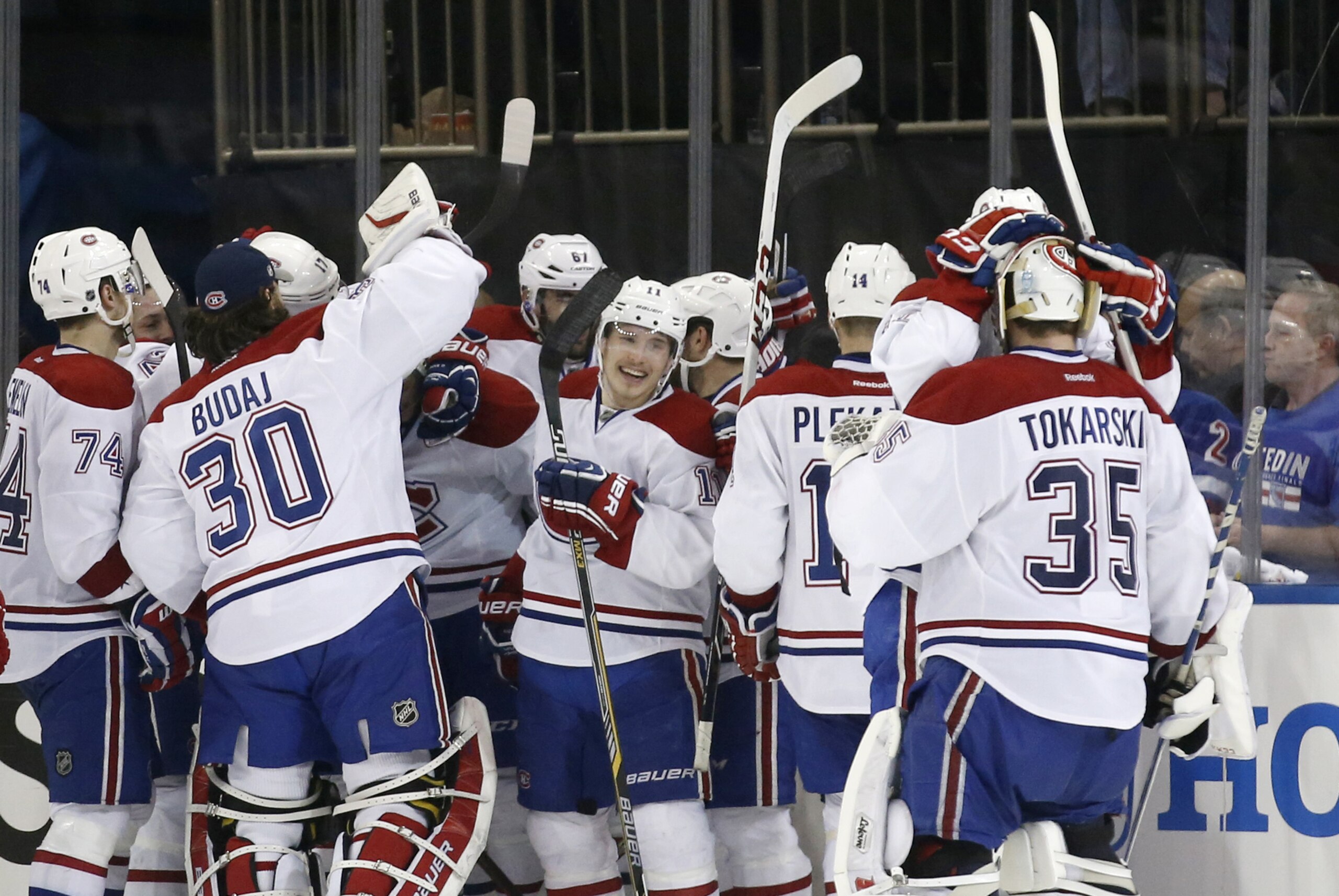 The Montreal Canadiens celebrate after defeating the New York Rangers 3-2 in overtime in Game 3 of the NHL hockey Stanley Cup playoffs Eastern Conference finals, Thursday, May 22, 2014, in New York. (AP Photo/Kathy Willens)