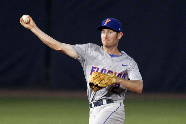 Florida's Casey Turgeon throws to first base for the out during the eighth inning against Mississippi State at the Southeastern Conference NCAA college baseball tournament on Friday, May 23, 2014, in Hoover, Ala. (AP Photo/Butch Dill)