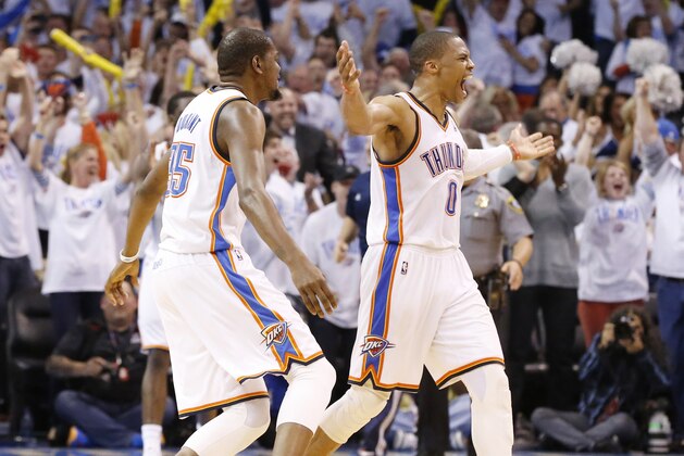 Oklahoma City Thunder forward Kevin Durant (35) celebrates with teammate Russell Westbrook, right, at the end of Game 5 of the Western Conference semifinal NBA basketball playoff series against the Los Angeles Clippers in Oklahoma City, Tuesday, May 13, 2014. Oklahoma City won 105-104. (AP Photo)