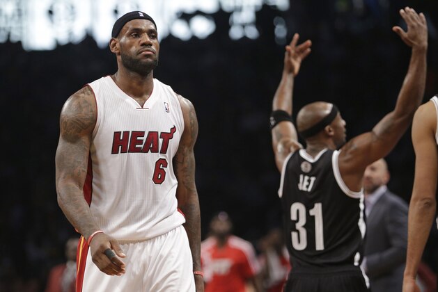 Miami Heat's LeBron James (6) walks toward the bench during a timeout in the first half of an NBA basketball game as Brooklyn Nets' Jason Terry (31) gestures to the crowd on Friday, Jan. 10, 2014, in New York. (AP Photo/Frank Franklin II)