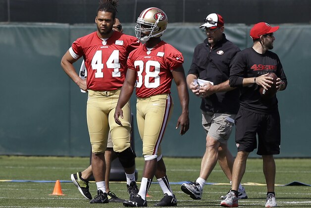 Fullback Trey Millard (44) and running back Marcus Lattimore (38) walk on the practice field during the San Francisco 49ers' NFL football rookie camp in Santa Clara, Calif., Friday, May 23, 2014. (AP Photo/Jeff Chiu)