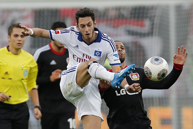 Hamburg's Hakan Calhanoglu of Turkey, left, and Leverkusen's Sidney Sam challenge for the ball during the German first division Bundesliga soccer match between Bayer Leverkusen and Hamburg SV in Leverkusen, Germany, Saturday, Nov. 9, 2013. (AP Photo/Frank Augstein)