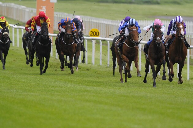 KILDARE, IRELAND - MAY 24:   James Doyle riding Kingman (2R) win The Tattersalls Irish 2,000 Guineas at Curragh racecourse on May 24, 2014 in Kildare, Ireland. (Photo by Alan Crowhurst/Getty Images)