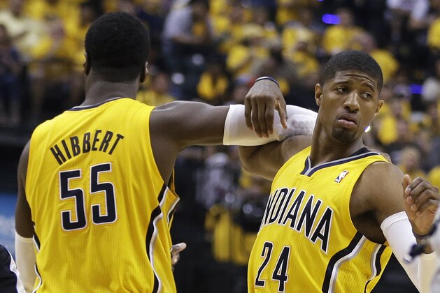 Indiana Pacers' Roy Hibbert (55) and Paul George celebrate during the second half of Game 1 of the Eastern Conference finals NBA basketball playoff series, Sunday, May 18, 2014, in Indianapolis. Indiana defeated Miami 107-96. (AP Photo/Darron Cummings)
