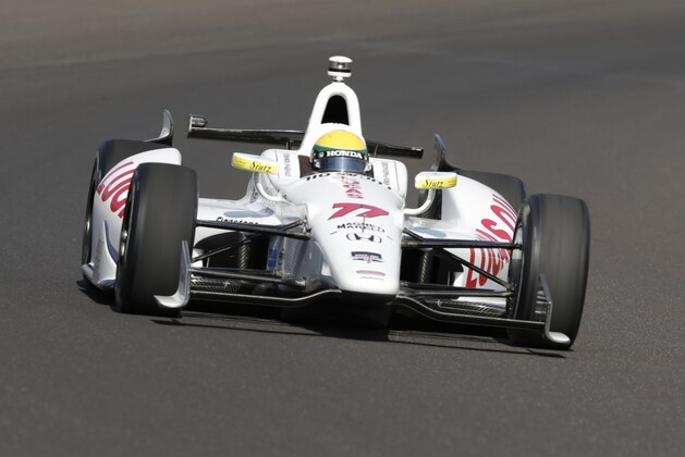 Simon Pagenaud, of France, drives through the first turn on the first day of qualifications for Indianapolis 500 IndyCar auto race at the Indianapolis Motor Speedway in Indianapolis, Saturday, May 17, 2014. (AP Photo/Dave Parker)