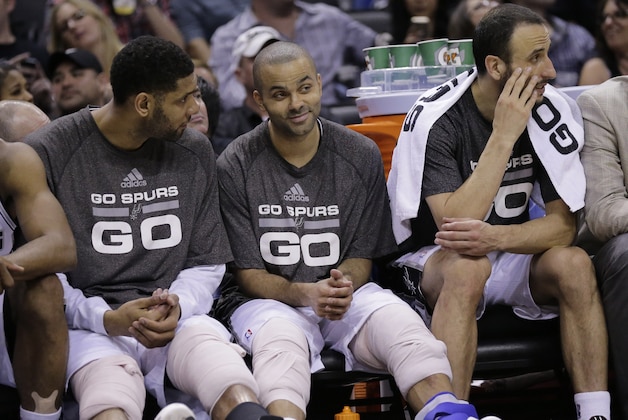 San Antonio Spurs' Tim Duncan, left, Tony Parker, center, and Manu Ginobili, right, sit on the bench during the second half of Game 2 of a Western Conference finals NBA basketball playoff series against the Oklahoma City Thunder, Wednesday, May 21, 2014, in San Antonio. San Antonio won 112-77. (AP Photo/Eric Gay)