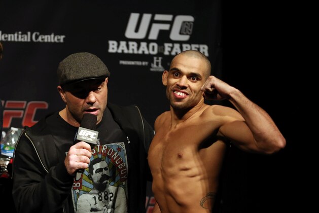 Jan 31, 2014; Newark, NJ, USA; Renan Barao (right) is interviewed by UFC commentator Joe Rogan after weighing in for his Bantamweight Championship bout against Urijah Faber (not pictured) at Prudential Center. Mandatory Credit: Joe Camporeale-USA TODAY Sports