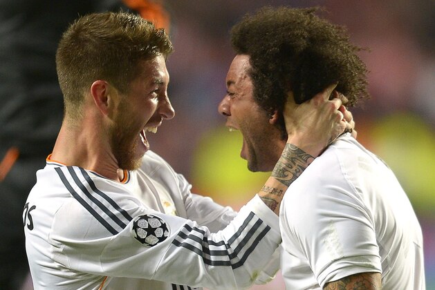 Real's Sergio Ramos, left,  celebrates with Real's Marcelo at the end of the Champions League final soccer match between Atletico Madrid and Real Madrid, at the Luz stadium, in Lisbon, Portugal, Saturday, May 24, 2014. (AP Photo/Manu Fernandez)