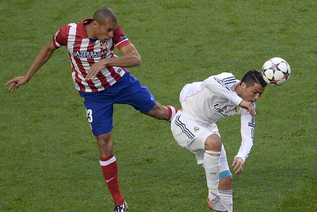 Atletico's Miranda, left, and Real's Cristiano Ronaldo vie for the ball during the Champions League final soccer match between Atletico Madrid and Real Madrid in Lisbon, Portugal, Saturday, May 24, 2014. (AP Photo/Paulo Duarte)