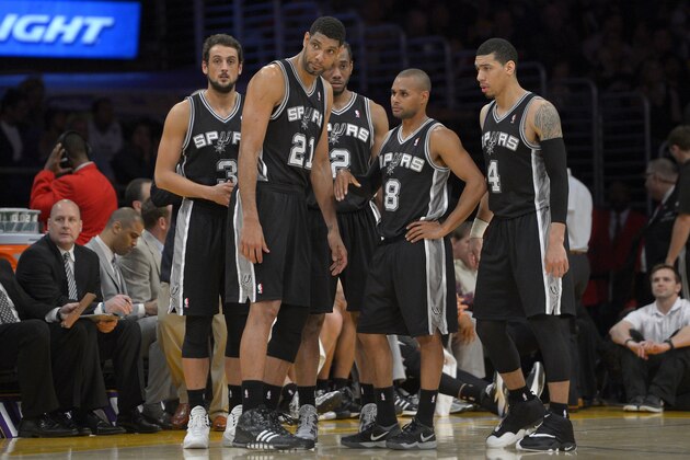 San Antonio Spurs, from left, Marco Belinelli, of Italy, Tim Duncan, Kawhi Leonard, Patty Mills, of Australia, and Danny Green wait during a timeout in the second half of their NBA basketball game, Wednesday, March 19, 2014, in Los Angeles. The Spurs won 125-109. (AP Photo/Mark J. Terrill)