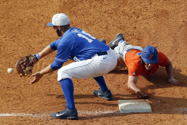 Florida's Harrison Bader beats the throw to Kentucky's A.J. Reed (18) as he dives back to first base during the fifth inning at the Southeastern Conference NCAA college baseball tournament Saturday, May 24, 2014, in Hoover, Ala. (AP Photo/Butch Dill)