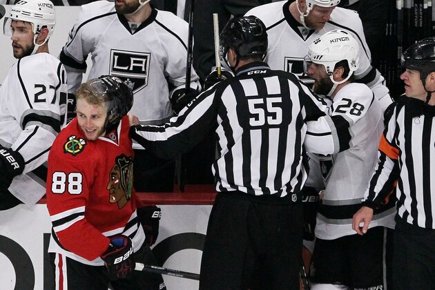 CHICAGO, IL - MAY 21:  Jarret Stoll #28 of the Los Angeles Kings and Patrick Kane #88 of the Chicago Blackhawks are separated by linesman Shane Heyer #55 in the second period in Game Two of the Western Conference Final during the 2014 Stanley Cup Playoffs at United Center on May 21, 2014 in Chicago, Illinois.  (Photo by Tasos Katopodis/Getty Images)